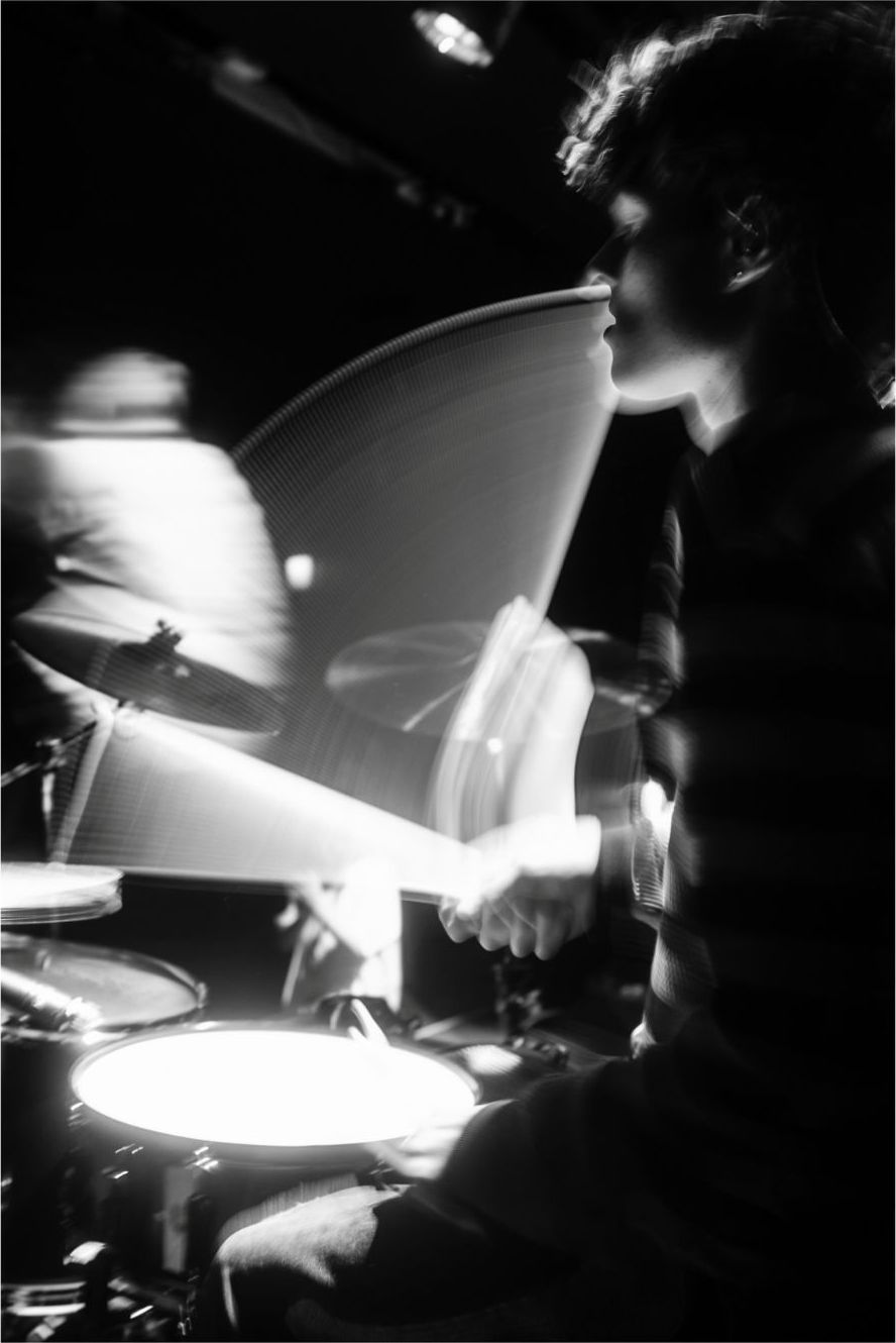 Troy performing, blurred with a slow shutter, in black and white